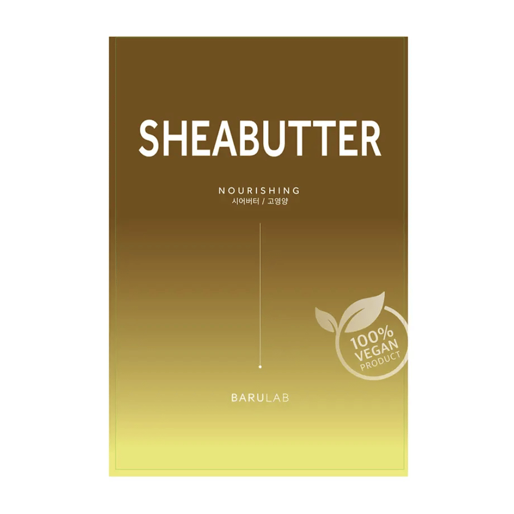 Μια συσκευασία της μάσκας "SHEABUTTER Nourishing" BARULAB, με την ένδειξη "100% Vegan Product". Η συσκευασία έχει ένα χρωματικό διαβαθμό που περνάει από σκούρο χρυσοκαφέ στην κορυφή σε ανοιχτό κίτρινο στο κάτω μέρος.