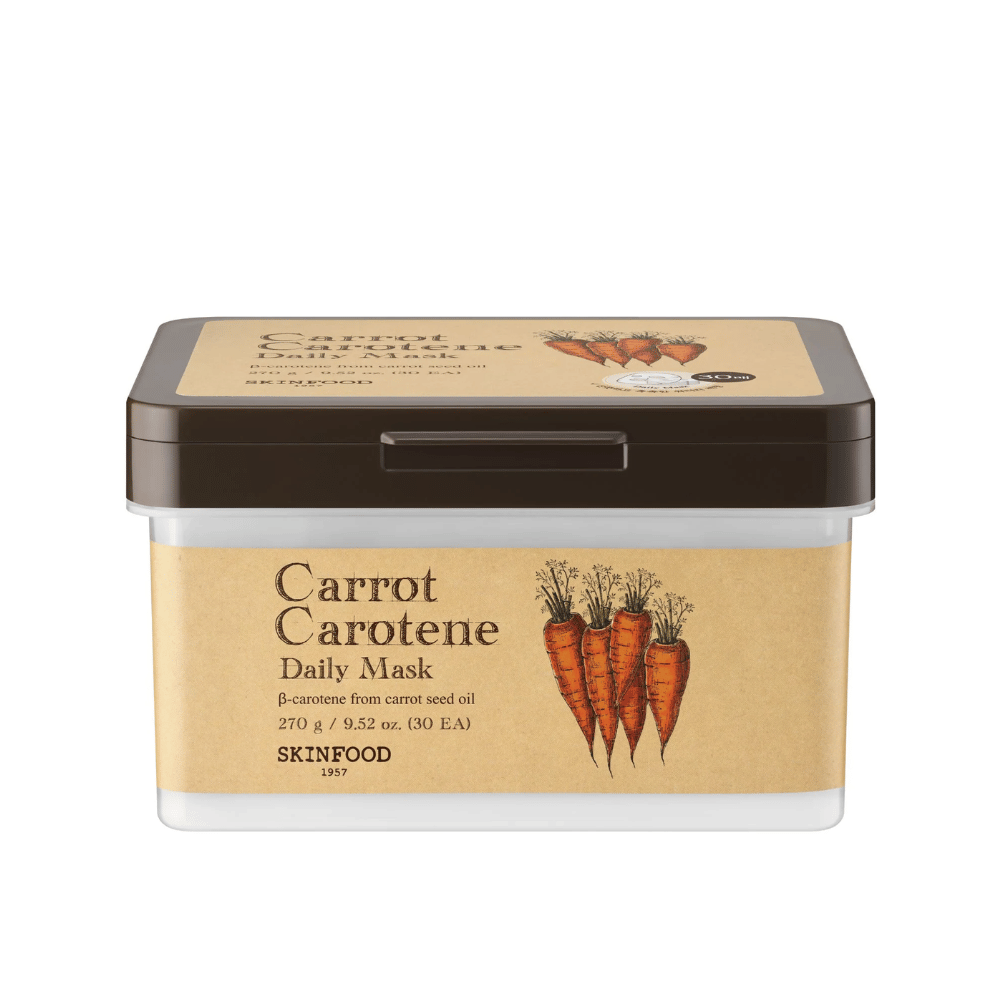 Μια συσκευασία "Carrot Carotene Daily Mask" από SKINFOOD, που περιέχει 30 μάσκες προσώπου. Το προϊόν είναι εμπλουτισμένο με β-καροτένιο από έλαιο σπόρων καρότου και είναι σχεδιασμένο για καθημερινή χρήση. Η συσκευασία είναι ανθεκτική με μια ετικέτα εμπνευσμένη από vintage που αναδεικνύει τα καρότα ως κύριο συστατικό.