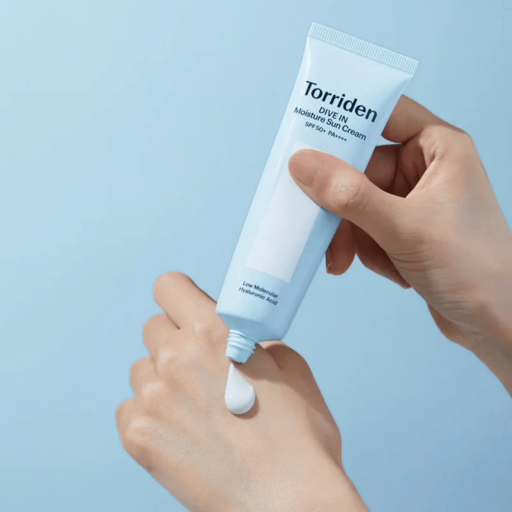 Torriden DIVE-IN Moisture Sun Cream SPF50+ PA++++ εφαρμόζεται στο χέρι για να δείξει την ελαφριά και κρεμώδη υφή της ενυδατικής αντηλιακής κρέμας.