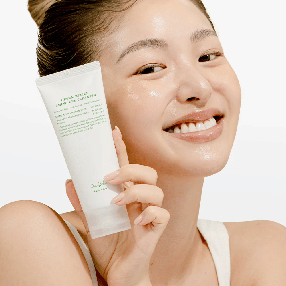 Γυναίκα με λαμπερό δέρμα κρατάει Dr. Althea Green Relief Amino Gel Cleanser – βίγκαν καθαριστικό για ευαίσθητο και ερεθισμένο δέρμα.