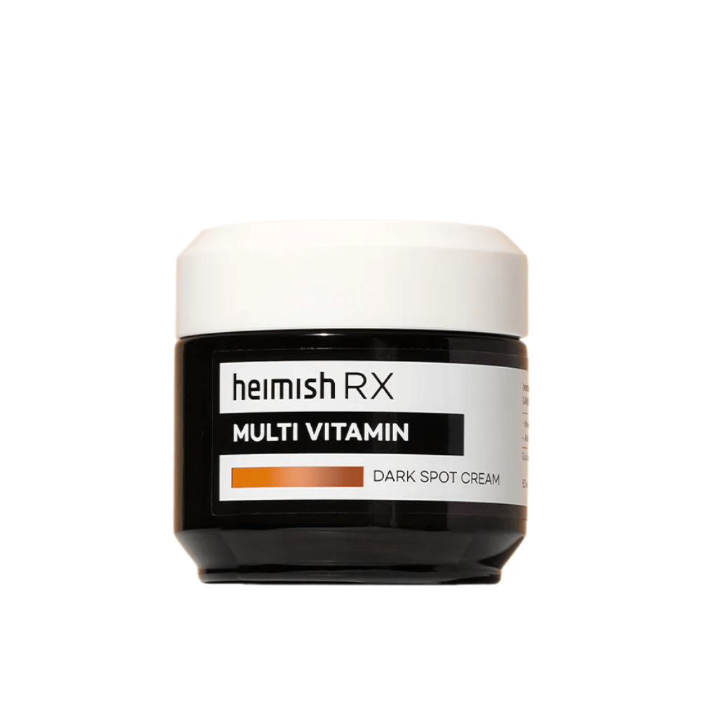 Heimish RX Multi Vitamin Dark Spot Cream σε ένα κομψό μαύρο βάζο με λευκό καπάκι. Μια κρέμα προσώπου εμπλουτισμένη με πολυβιταμίνες, σχεδιασμένη για να μειώνει τις σκούρες κηλίδες και να εξομαλύνει τον τόνο του δέρματος.