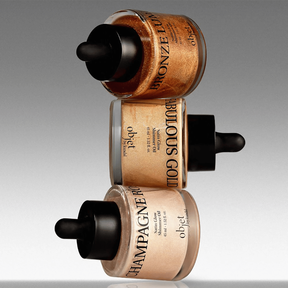 Objet by KUNDAL Satin Glow Shimmer Oil στο Bronze Lumière, Fabulous Gold και Champagne Rose – λαμπερά λάδια σώματος με φινίρισμα που χαρίζει λάμψη.