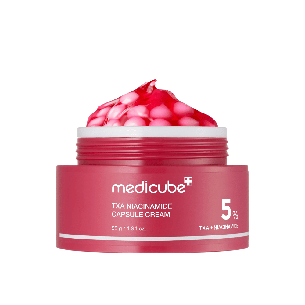 Medicube TXA Niacinamide Capsule Cream σε βάζο με ροζ κάψουλες σε μορφή ζελέ, δείχνοντας σαφή σήμανση προϊόντος με 5% TXA + Νιασιναμίδη.