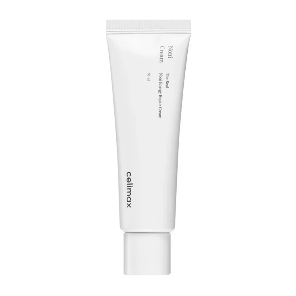 Celimax Noni Energy Repair Cream σε λευκό σωληνάριο με μαύρο κείμενο. Το προϊόν είναι επισημασμένο ως "The Real Noni Energy Repair Cream" και έχει όγκο 50 ml.