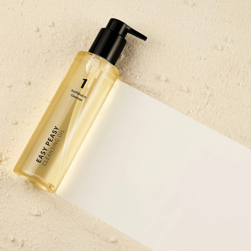 Numbuzin No.1 Easy Peasy Cleansing Oil που βρίσκεται σε επιφάνεια χρώματος άμμου με σκιά.